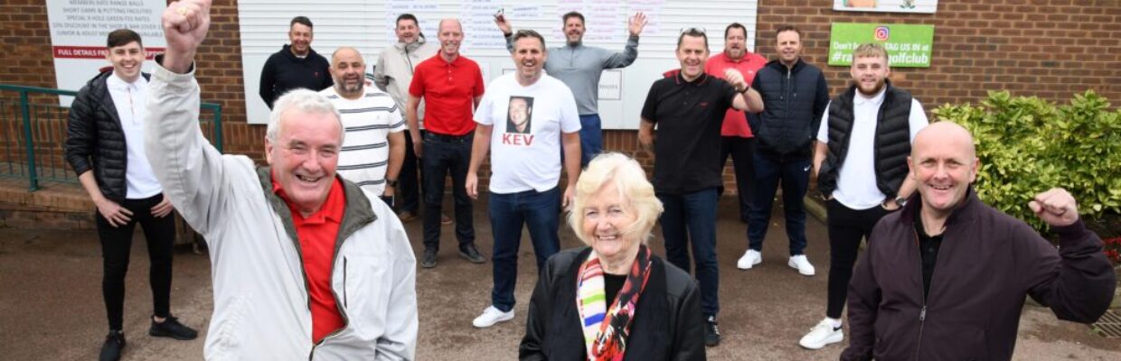 Charity golf group smiling.