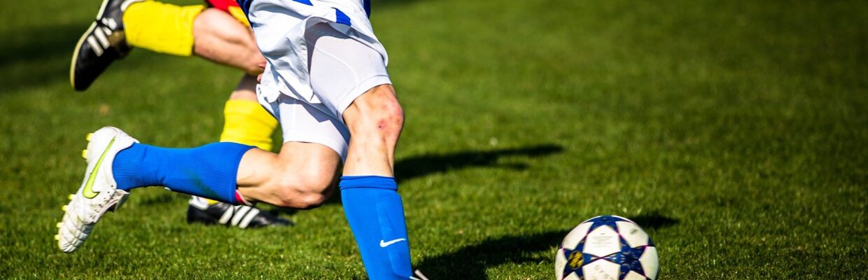 Footballer kicking ball.