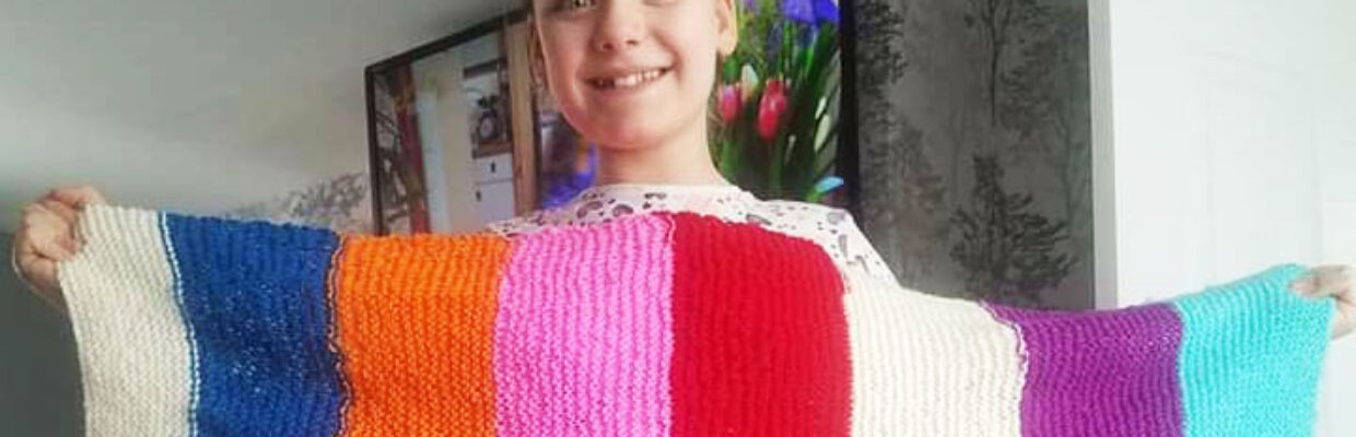 Gabrielle Rutherford holding her homemade scarf.