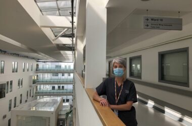 A nurse wearing a mask stood in a hospital hallway