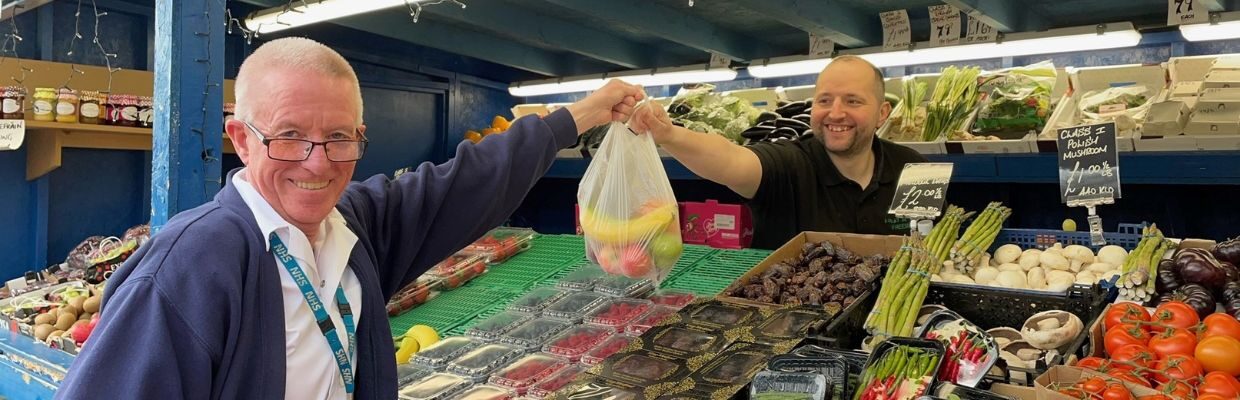 A staff member collects a free bag of fruit at Newcastle Hospitals, as part of Nutrition and Hydration Week