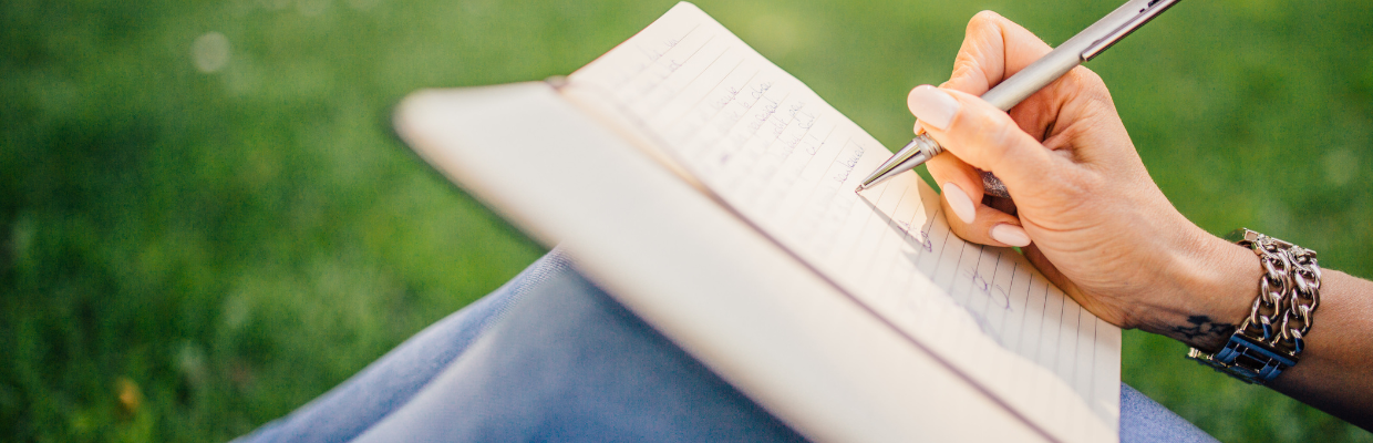 Photo of someone writing in a book