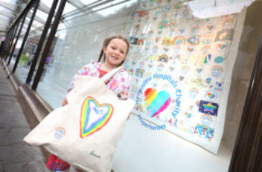 Girl holding Newcastle Charity bag.